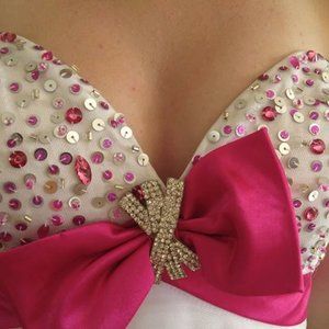 Short white and hot pink gown with crystal accent bow